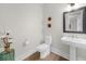 Powder room featuring contemporary fixtures, a pedestal sink, and decorative accents at 145 Canton St, Alpharetta, GA 30009