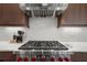 Close-up of the stainless steel kitchen range with red knobs, set against a decorative backsplash at 145 Canton St, Alpharetta, GA 30009