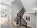 Carpeted staircase with black railings and modern artwork leading to the upper level at 145 Canton St, Alpharetta, GA 30009