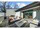 Outdoor terrace featuring a fire pit, modern seating, and sliding door access to interior at 145 Canton St, Alpharetta, GA 30009