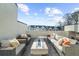 Outdoor terrace with modern wicker seating, a fire pit, and neighborhood views at 145 Canton St, Alpharetta, GA 30009