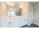 Elegant bathroom with double sinks, white cabinets, quartz countertop, and modern fixtures at 1730 Fulmont Cir, Mableton, GA 30126