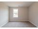 Neutral bedroom offers carpet, neutral paint, and natural light from a large window at 1730 Fulmont Cir, Mableton, GA 30126