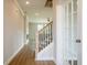 Elegant hallway with hardwood floors, a staircase with rod iron, and natural light through a glass panel door at 1730 Fulmont Cir, Mableton, GA 30126