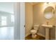 Charming powder room features a pedestal sink, stylish mirror, and wood-look flooring at 1730 Fulmont Cir, Mableton, GA 30126