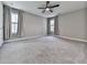 Spacious bedroom with gray carpet, two windows, gray walls, and a ceiling fan at 1020 Broadview Dr, Marietta, GA 30062