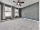 Bedroom featuring neutral carpet, gray walls, a ceiling fan, and two windows at 1020 Broadview Dr, Marietta, GA 30062