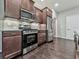 Close-up of stainless steel appliances and dark wood cabinets in a modern kitchen at 1020 Broadview Dr, Marietta, GA 30062