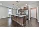 Modern kitchen featuring a large center island, stainless steel appliances, and a seamless flow to the adjoining living area at 1020 Broadview Dr, Marietta, GA 30062