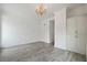 Bedroom has stylish floors, a chandelier, and built in cabinets and white walls at 3636 Peachtree Ne Rd # 405, Atlanta, GA 30319
