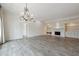 Expansive living room featuring beautiful flooring, a chandelier, and built-in shelving with a fireplace at 3636 Peachtree Ne Rd # 405, Atlanta, GA 30319