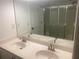 Bathroom featuring double sinks, a large mirror, and a walk-in shower at 5148 Centennial Creek Nw Vw, Acworth, GA 30102