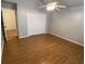 Bright bedroom featuring wood-look floors, double closet, and a ceiling fan at 5148 Centennial Creek Nw Vw, Acworth, GA 30102