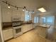 Well-lit kitchen with white cabinetry, tile floors, and a functional center island at 5148 Centennial Creek Nw Vw, Acworth, GA 30102