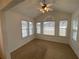 Sunny sunroom with vaulted ceiling, fan, and multiple windows allowing ample sunlight at 5148 Centennial Creek Nw Vw, Acworth, GA 30102