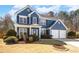 Charming two-story blue home featuring a two-car garage and well-maintained landscaping at 6158 Brookmere Pl, Mableton, GA 30126