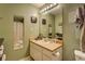 Clean bathroom with a vanity, large mirror, and a combined shower and tub at 6661 Gina Agha Cir, Lithonia, GA 30038