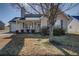 Attractive home with a welcoming porch, complemented by mature trees and a neat front yard at 6661 Gina Agha Cir, Lithonia, GA 30038