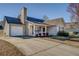 Home with a white porch, matching trim, and a two-car garage at 6661 Gina Agha Cir, Lithonia, GA 30038