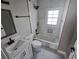 Modern bathroom with white subway tile, sleek fixtures, and ample natural light from the window above the tub at 673 Pearce Sw St, Atlanta, GA 30310