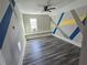 Empty bedroom with hardwood floors, bright window and custom painted walls at 673 Pearce Sw St, Atlanta, GA 30310