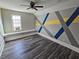 Empty bedroom with hardwood floors, bright window and custom painted walls at 673 Pearce Sw St, Atlanta, GA 30310