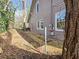 Side view of a gray home featuring a small side yard and gravel path at 673 Pearce Sw St, Atlanta, GA 30310