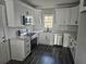 Modern kitchen with white cabinets, stainless steel appliances, and a window at 673 Pearce Sw St, Atlanta, GA 30310