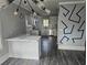 Bright kitchen featuring white cabinets, stainless steel appliances, and an adjacent dining area at 673 Pearce Sw St, Atlanta, GA 30310