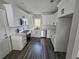 Bright kitchen with white cabinetry, stainless steel appliances and wood floor at 673 Pearce Sw St, Atlanta, GA 30310