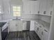 Bright kitchen featuring white cabinets, stainless steel appliances, and marble countertops at 673 Pearce Sw St, Atlanta, GA 30310