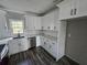 Bright kitchen featuring white cabinets, stainless steel dishwasher, and modern countertops at 673 Pearce Sw St, Atlanta, GA 30310