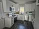 Modern kitchen featuring white cabinets, stainless steel appliances, and subway tile at 673 Pearce Sw St, Atlanta, GA 30310