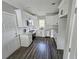 Modern kitchen with white cabinets, stainless steel appliances, and gray-toned wood floors at 673 Pearce Sw St, Atlanta, GA 30310