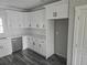 A well-lit kitchen with white cabinets, subway tile backsplash, and stainless steel appliances at 673 Pearce Sw St, Atlanta, GA 30310