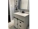 Bathroom featuring a modern vanity, marble floors, and a wall mounted hair dryer at 687 N Hairston Rd, Stone Mountain, GA 30083