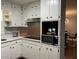 Cozy kitchen featuring stainless steel appliances, white cabinets, and an eat-in dining area at 687 N Hairston Rd, Stone Mountain, GA 30083