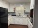 Well-maintained kitchen with all-white cabinets and a view from the window above the sink at 687 N Hairston Rd, Stone Mountain, GA 30083