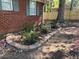 A close up view of a landscaped garden area on the side of the home with new fencing at 687 N Hairston Rd, Stone Mountain, GA 30083