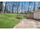 Spacious backyard featuring green lawn, rock border landscaping, and storage shed at 881 Brighton Dr, Lawrenceville, GA 30043