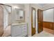 Bathroom vanity with mirror and cabinet, tile flooring, and doorway to another room at 881 Brighton Dr, Lawrenceville, GA 30043