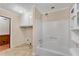 Bathroom featuring a bathtub/shower, toilet, cabinets, and a doorway leading to another area at 881 Brighton Dr, Lawrenceville, GA 30043