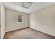 Bedroom with a window, carpeted flooring, and neutral-colored walls providing a blank canvas at 881 Brighton Dr, Lawrenceville, GA 30043