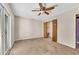 Bedroom with a ceiling fan, closet with wood doors, and access to the exterior at 881 Brighton Dr, Lawrenceville, GA 30043