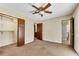 Bedroom featuring a ceiling fan, closet with shelving, and doorways to other rooms and a bathroom at 881 Brighton Dr, Lawrenceville, GA 30043