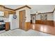 Functional Kitchen features wooden cabinets, a white refrigerator, and laminate flooring at 881 Brighton Dr, Lawrenceville, GA 30043