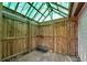 Enclosed storage shed with wood plank siding, fencing, and translucent roof paneling at 881 Brighton Dr, Lawrenceville, GA 30043