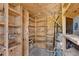 Interior view of the storage shed, featuring wooden shelving and water heater at 881 Brighton Dr, Lawrenceville, GA 30043