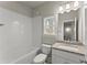 Well-lit bathroom featuring white subway tile, a granite countertop, and a tub and shower combination at 1286 Brookins Trl, Atlanta, GA 30316