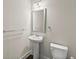 Bathroom features a pedestal sink, toilet and decorative mirror at 1286 Brookins Trl, Atlanta, GA 30316